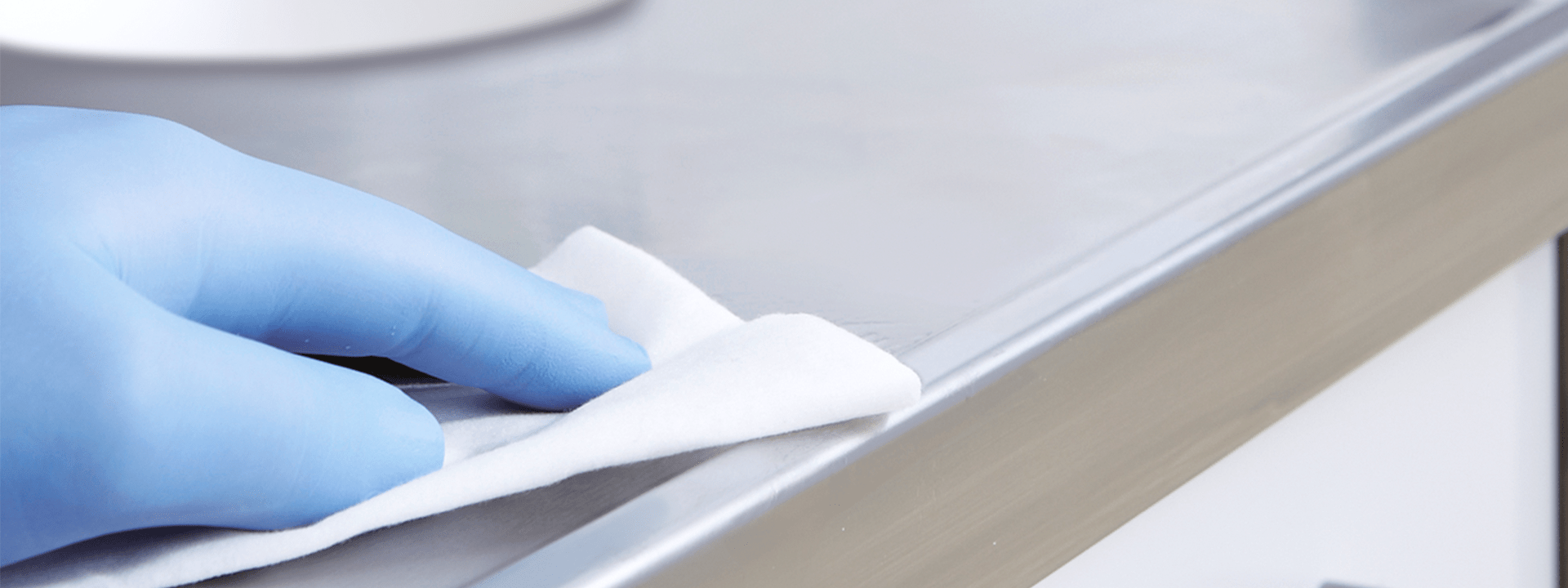 Image hand disinfects surface by wiping