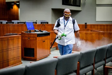 staff spray disinfectant in office, public spaces