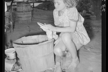 Daughter migrant family wiping packing