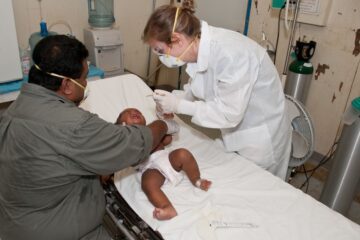 baby lying down on hospital bed getting a check up