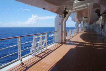 cruise ship deck overlooking blue ocean water