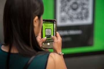 woman taking photos of a qr code with a smartphone